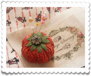 Pincushions and vintage buttons made with yo-yo quilts