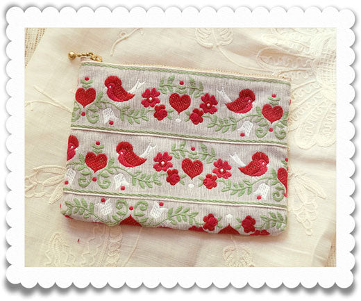 Pouch made of jacquard ribbon with folk art pattern