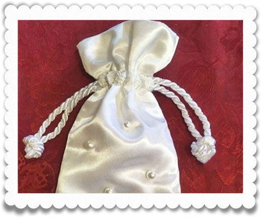 A stylish drawstring bag that opens and closes with a pearl cord.